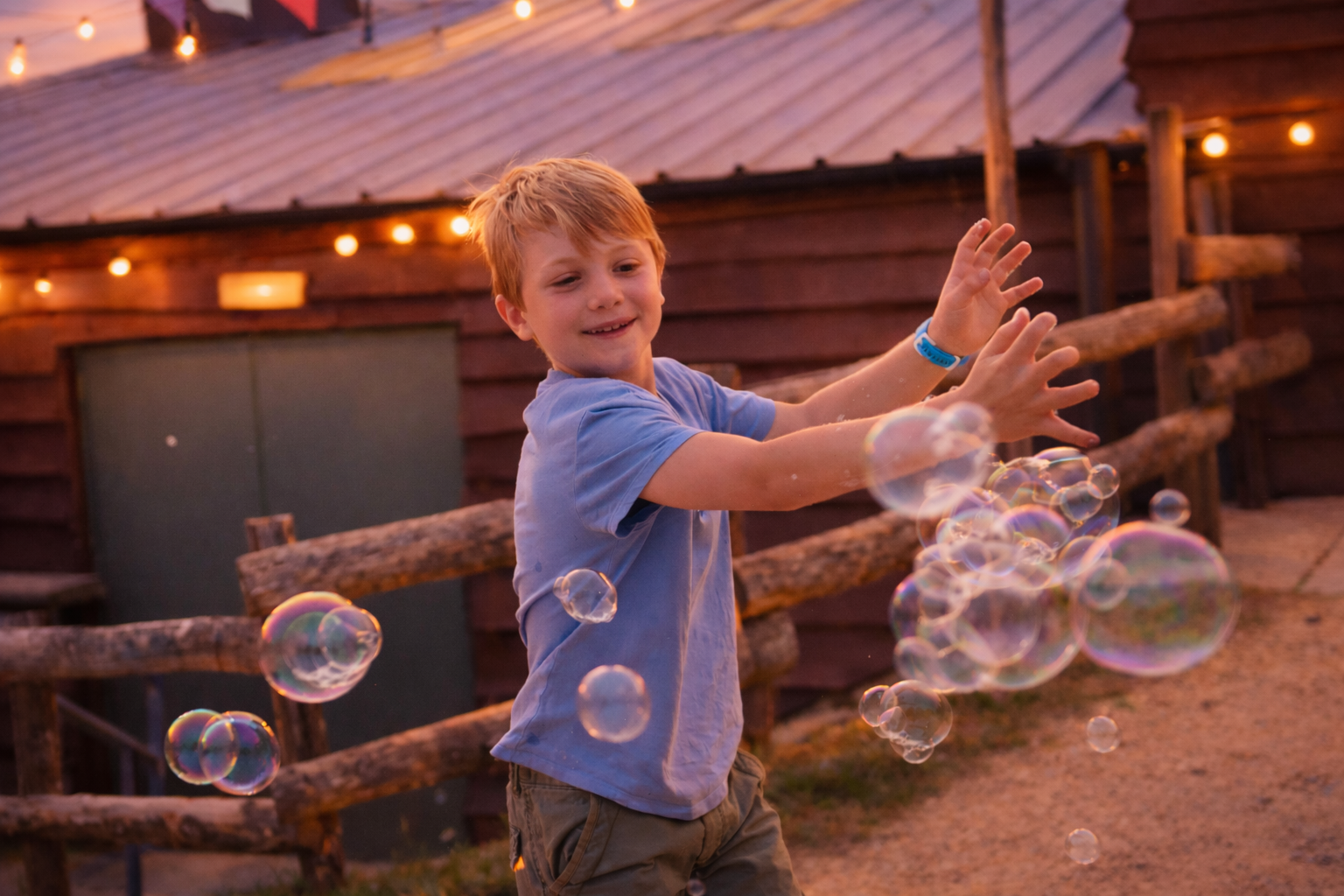 Child enjoying bubbles during Twilight at Watermouth Castle family attraction in North Devon